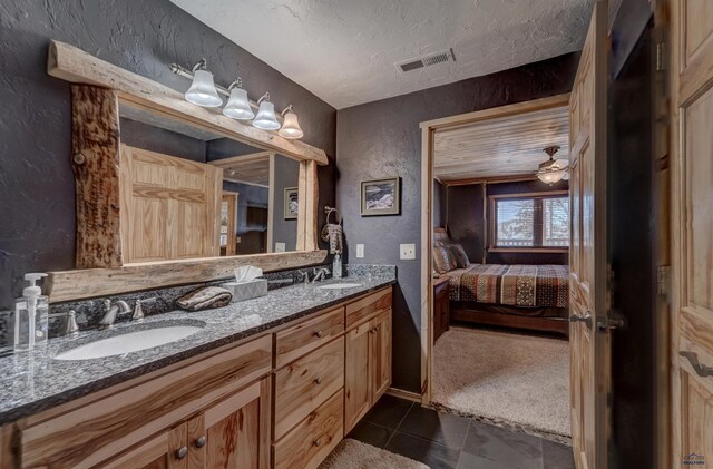 bathroom with vanity, tile patterned floors, and a textured ceiling
