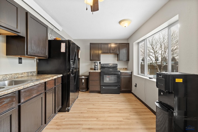 kitchen with ceiling fan, light hardwood / wood-style floors, dark brown cabinets, and black appliances