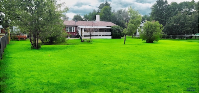 view of yard featuring a sunroom