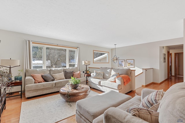 living room featuring a textured ceiling and light wood-type flooring