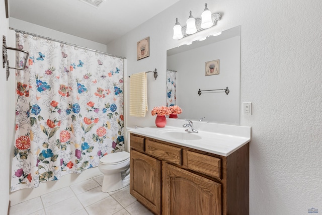 1021 Alta Vista Dr, Rapid City, SD 57701 - bathroom with tile patterned floors, toilet, vanity, and a textured wall