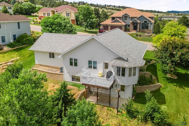 rear view of house featuring a deck