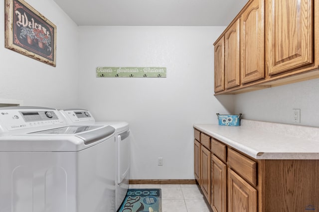1021 Alta Vista Dr, Rapid City, SD 57701 - laundry room with cabinet space, washer and clothes dryer, light tile patterned floors, and baseboards