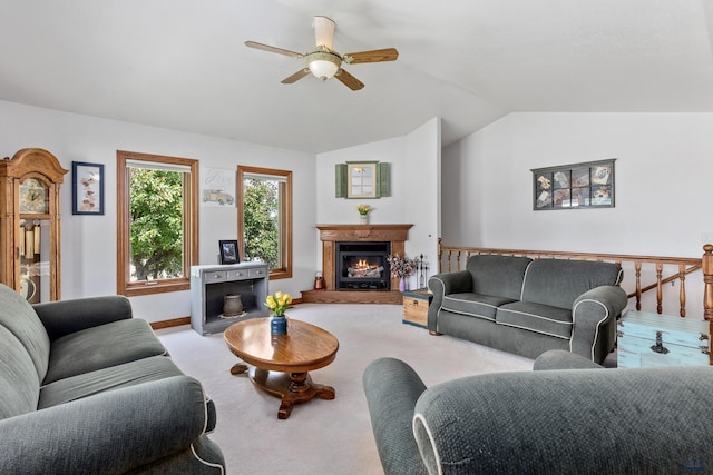 carpeted living room featuring vaulted ceiling and ceiling fan