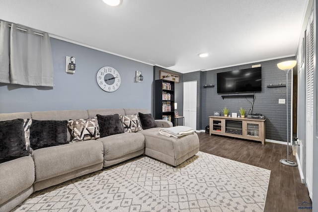 living room featuring hardwood / wood-style flooring and ornamental molding