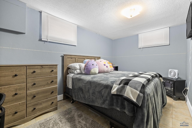 tiled bedroom with a textured ceiling