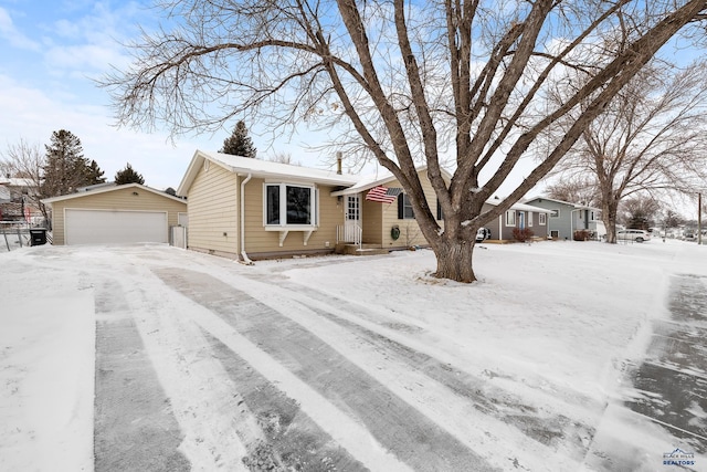 single story home with a garage and an outbuilding