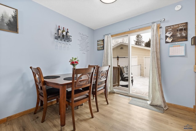 dining space with light hardwood / wood-style floors