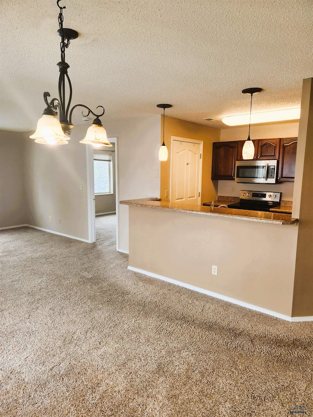 kitchen featuring pendant lighting, appliances with stainless steel finishes, dark brown cabinets, carpet flooring, and a textured ceiling