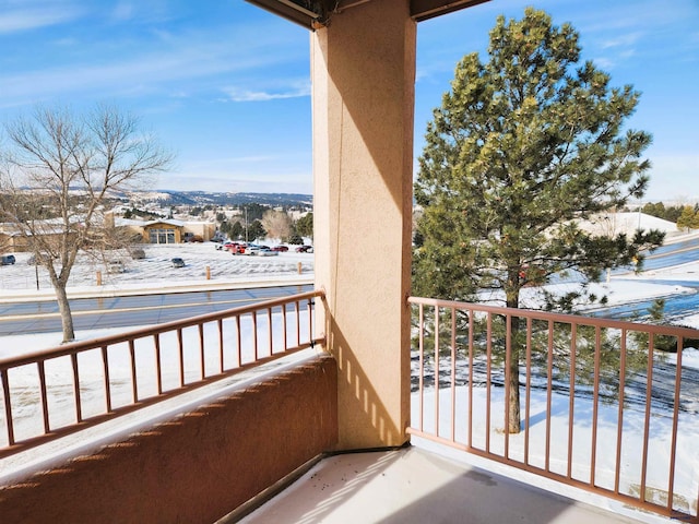 view of snow covered back of property