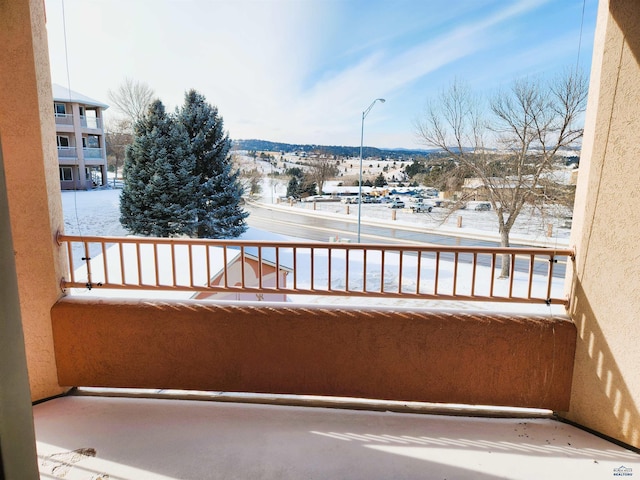 view of snow covered back of property