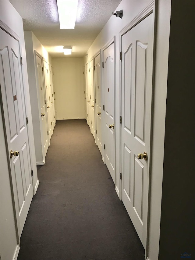 hallway featuring a textured ceiling