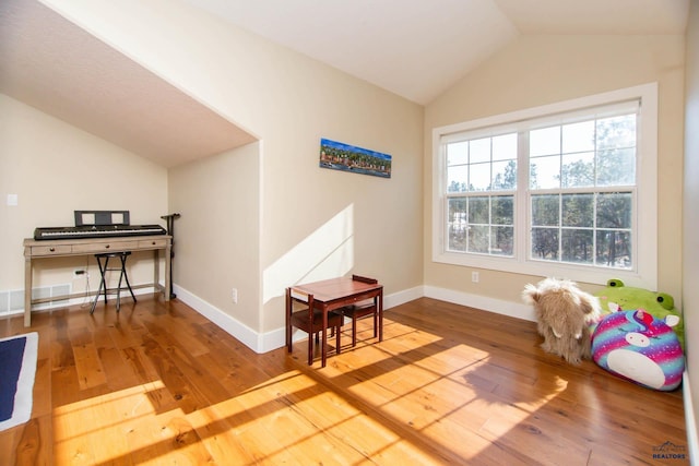 playroom featuring vaulted ceiling and hardwood / wood-style floors