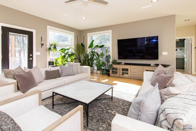 living room with wood-type flooring and ceiling fan