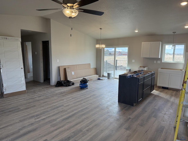 1051 Cobalt Dr, Rapid City, SD 57701 - kitchen featuring pendant lighting, lofted ceiling, wood finished floors, and ceiling fan with notable chandelier