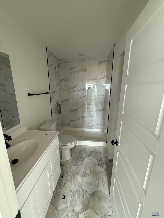 648 Valor Ct, Box Elder, SD 57719 - full bath with marble look tile flooring, toilet, vanity, and tiled shower