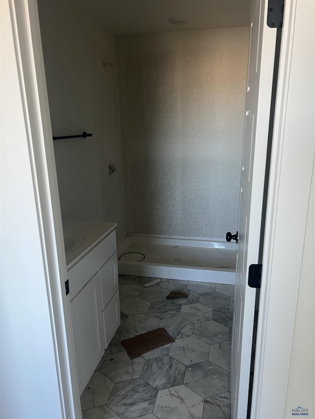 648 Valor Ct, Box Elder, SD 57719 - full bathroom with a shower stall, marble look tiles, and vanity
