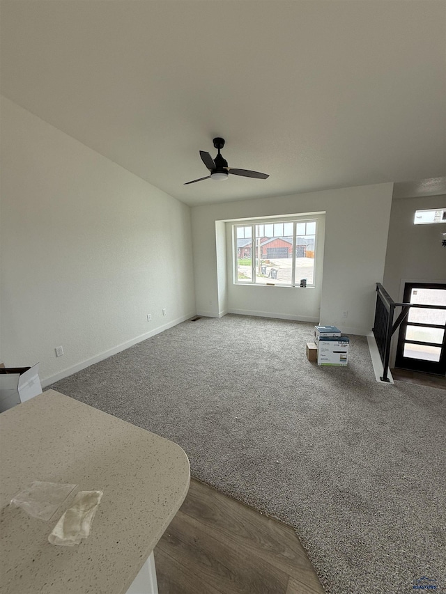 648 Valor Ct, Box Elder, SD 57719 - unfurnished living room featuring a ceiling fan, carpet, and baseboards