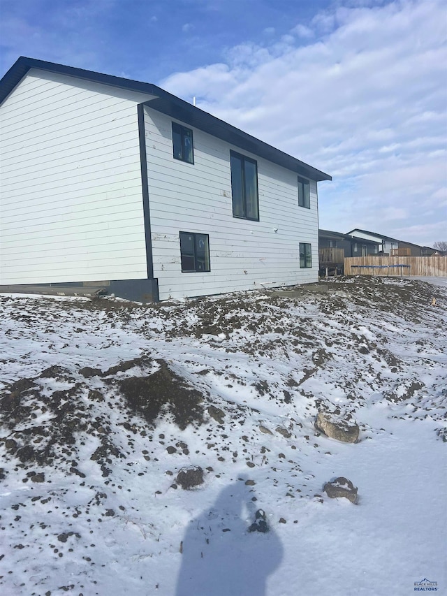 view of snow covered rear of property