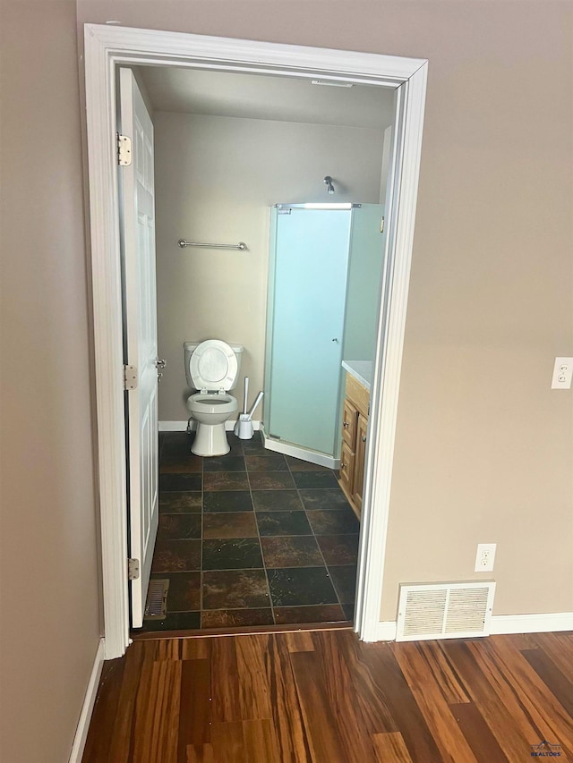 bathroom featuring vanity, hardwood / wood-style floors, and toilet