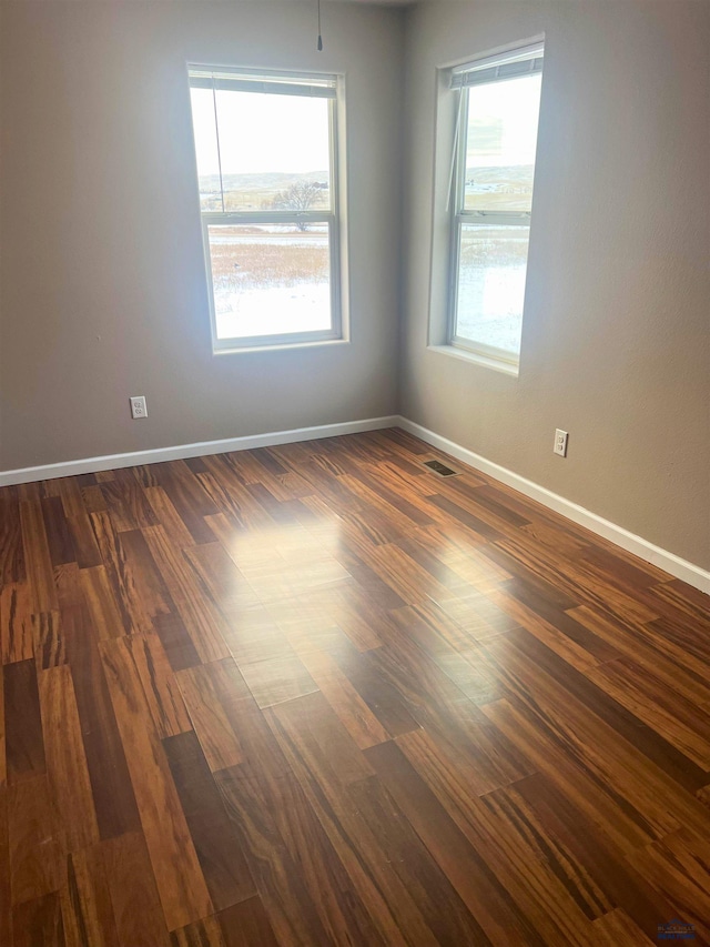 empty room featuring dark wood-type flooring