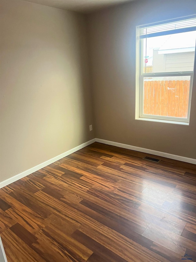 spare room with dark hardwood / wood-style floors