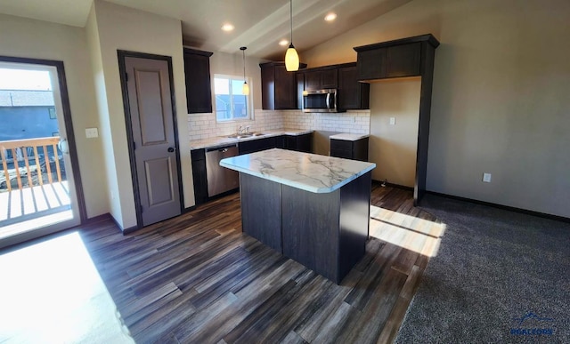 kitchen featuring a kitchen island, pendant lighting, tasteful backsplash, sink, and stainless steel appliances