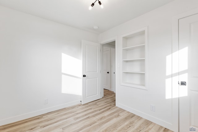 unfurnished bedroom with light wood-type flooring