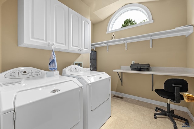 washroom with independent washer and dryer and cabinets