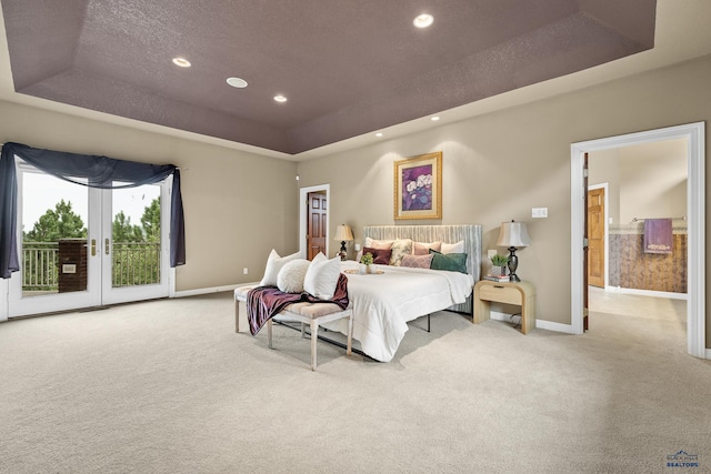 carpeted bedroom featuring access to outside, a raised ceiling, a textured ceiling, and french doors