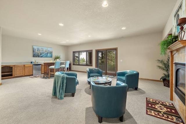 carpeted living room with a fireplace and a textured ceiling