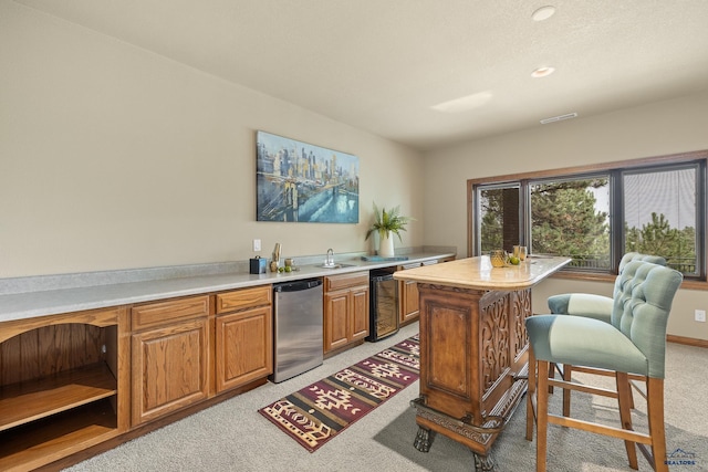 kitchen featuring refrigerator, a center island, sink, and light carpet