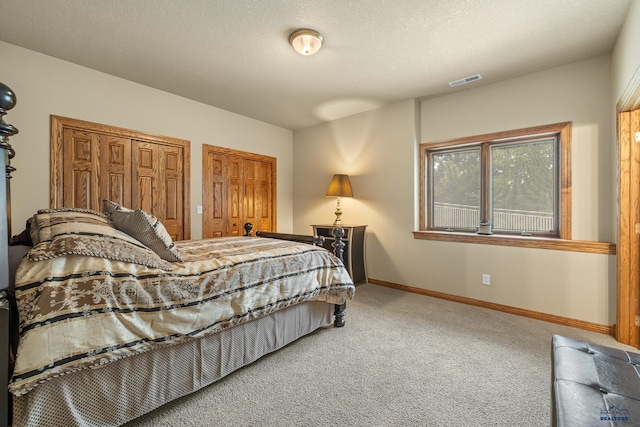 carpeted bedroom with a textured ceiling