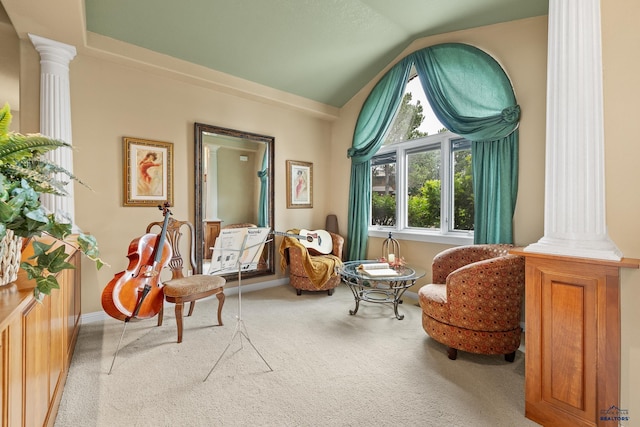 sitting room featuring ornate columns, carpet, and lofted ceiling