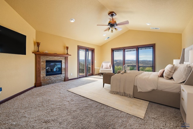 bedroom featuring vaulted ceiling, a fireplace, carpet flooring, access to exterior, and ceiling fan