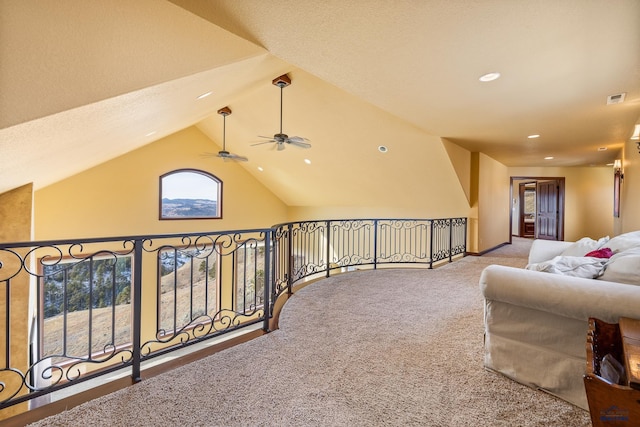 hallway featuring light carpet and lofted ceiling