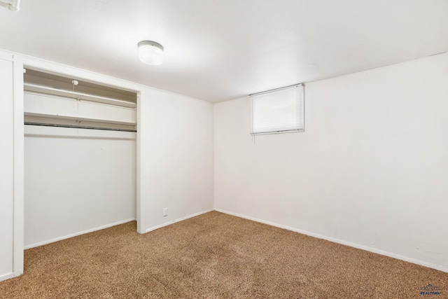 unfurnished bedroom with a closet and carpet flooring