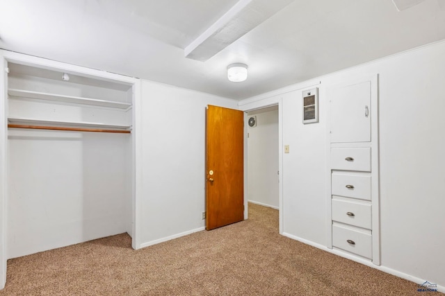 unfurnished bedroom featuring light carpet and a closet