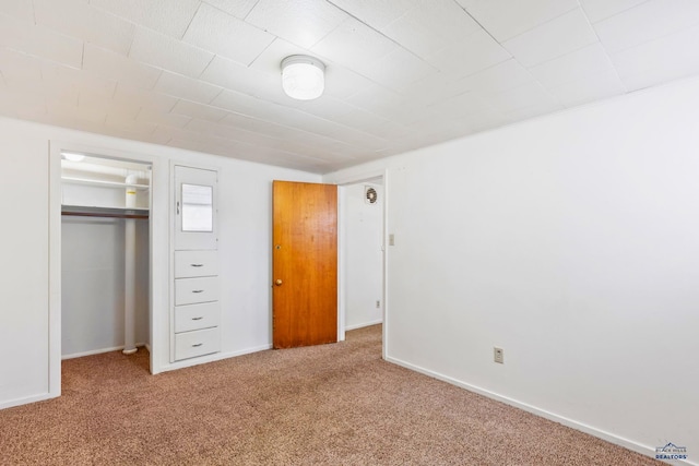 unfurnished bedroom featuring a closet and carpet floors