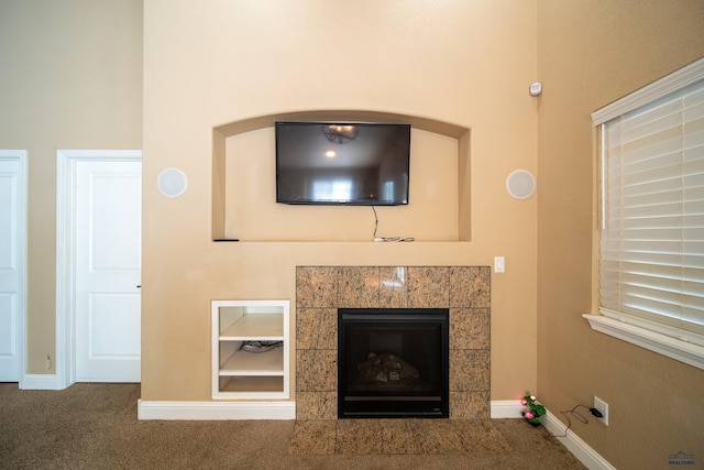 room details with carpet and a tile fireplace