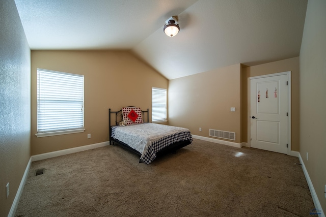 bedroom with multiple windows, vaulted ceiling, and carpet floors