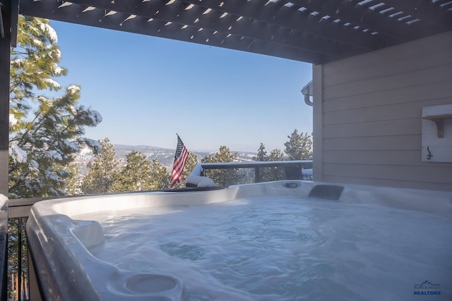 view of swimming pool featuring a mountain view and a hot tub