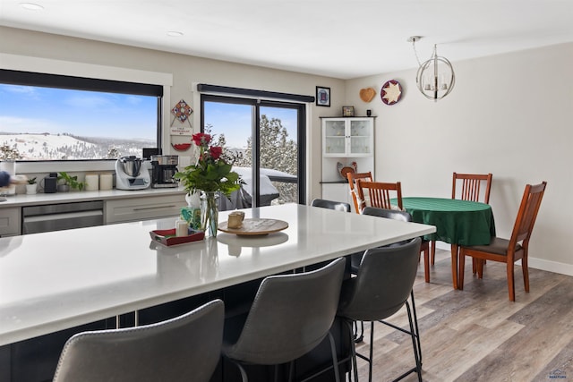 dining area featuring light hardwood / wood-style floors and an inviting chandelier