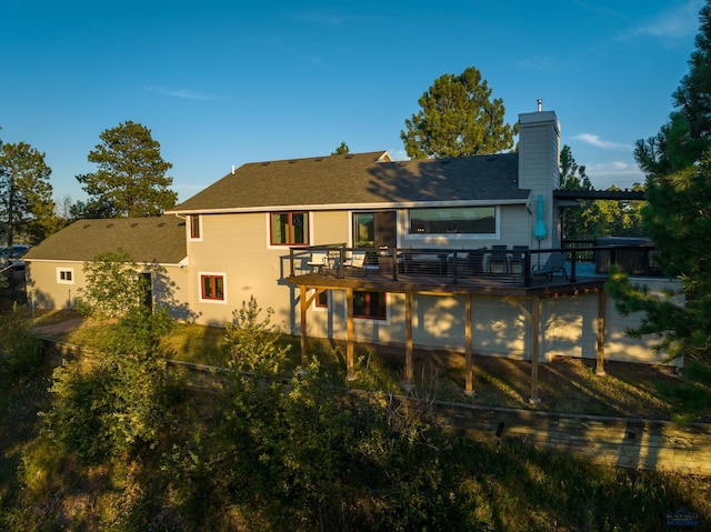 rear view of property featuring a deck