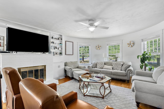 1016 W Blvd, Rapid City, SD 57701 - living area featuring ceiling fan, a brick fireplace, and light wood-style flooring