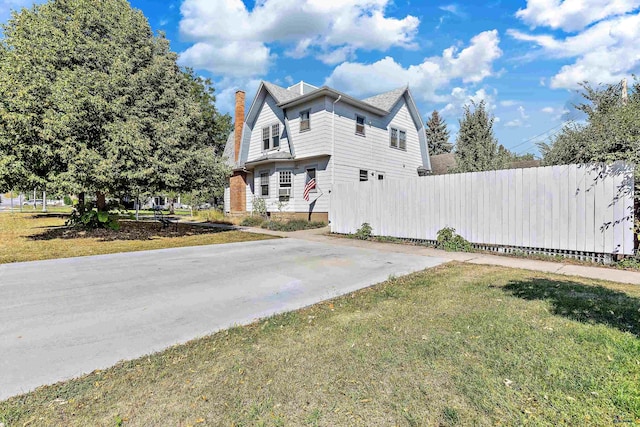 1016 W Blvd, Rapid City, SD 57701 - view of home's exterior with a lawn, a chimney, and fence