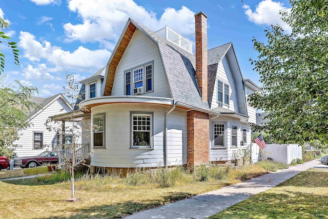 1016 W Blvd, Rapid City, SD 57701 - view of side of property with a shingled roof, fence, a gambrel roof, a yard, and a chimney
