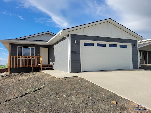 1154 Cobalt Dr, Rapid City, SD 57701 - ranch-style house featuring a garage, driveway, board and batten siding, and covered porch
