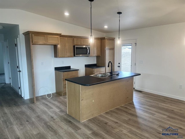 1154 Cobalt Dr, Rapid City, SD 57701 - kitchen featuring stainless steel microwave, a sink, vaulted ceiling, dark countertops, and dark wood-type flooring