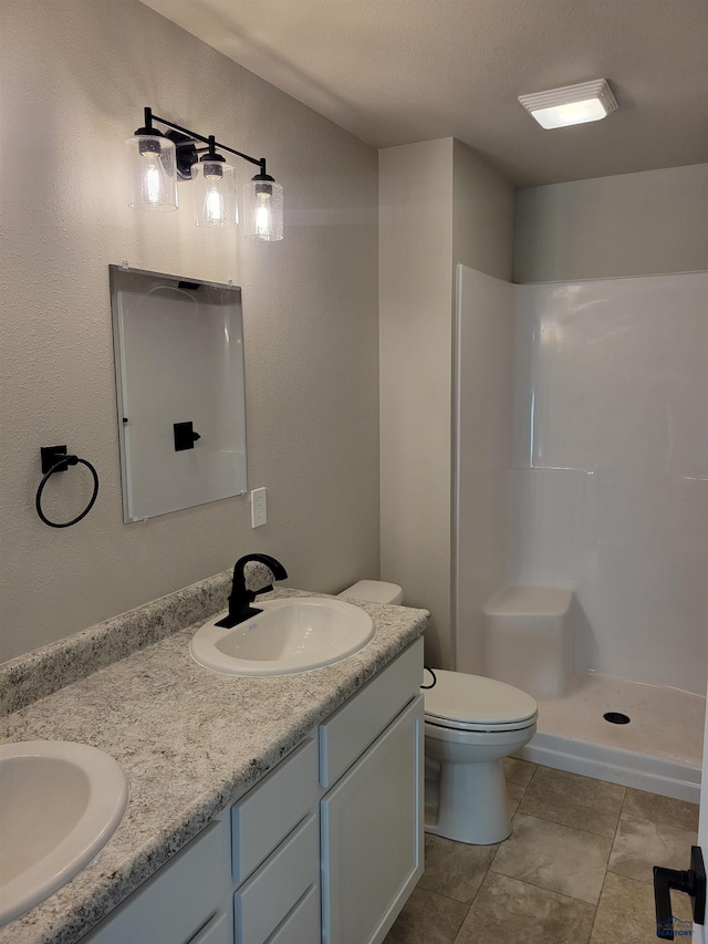1154 Cobalt Dr, Rapid City, SD 57701 - bathroom with double vanity, tile patterned flooring, a shower, and toilet